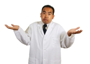 Asian man in a lab coat giving a shrug on a white background